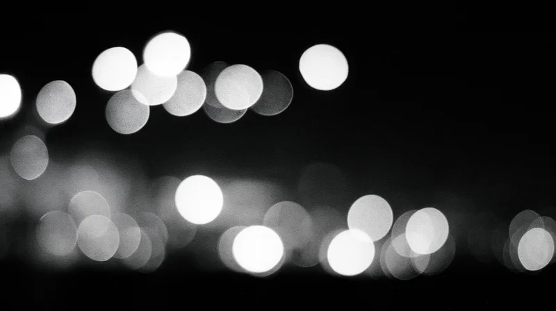 Blurred circular lights arranged in rows against a dark background