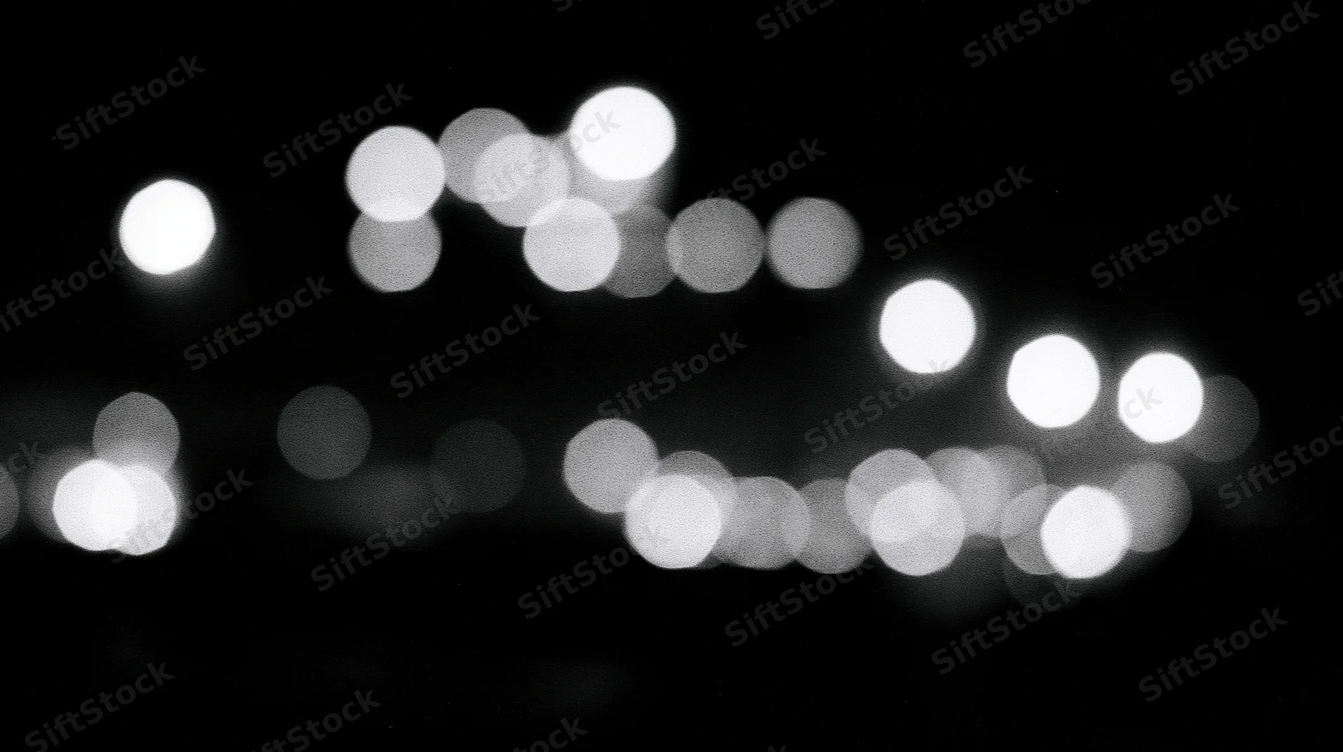 Blurred circular lights arranged in a pattern against a dark background