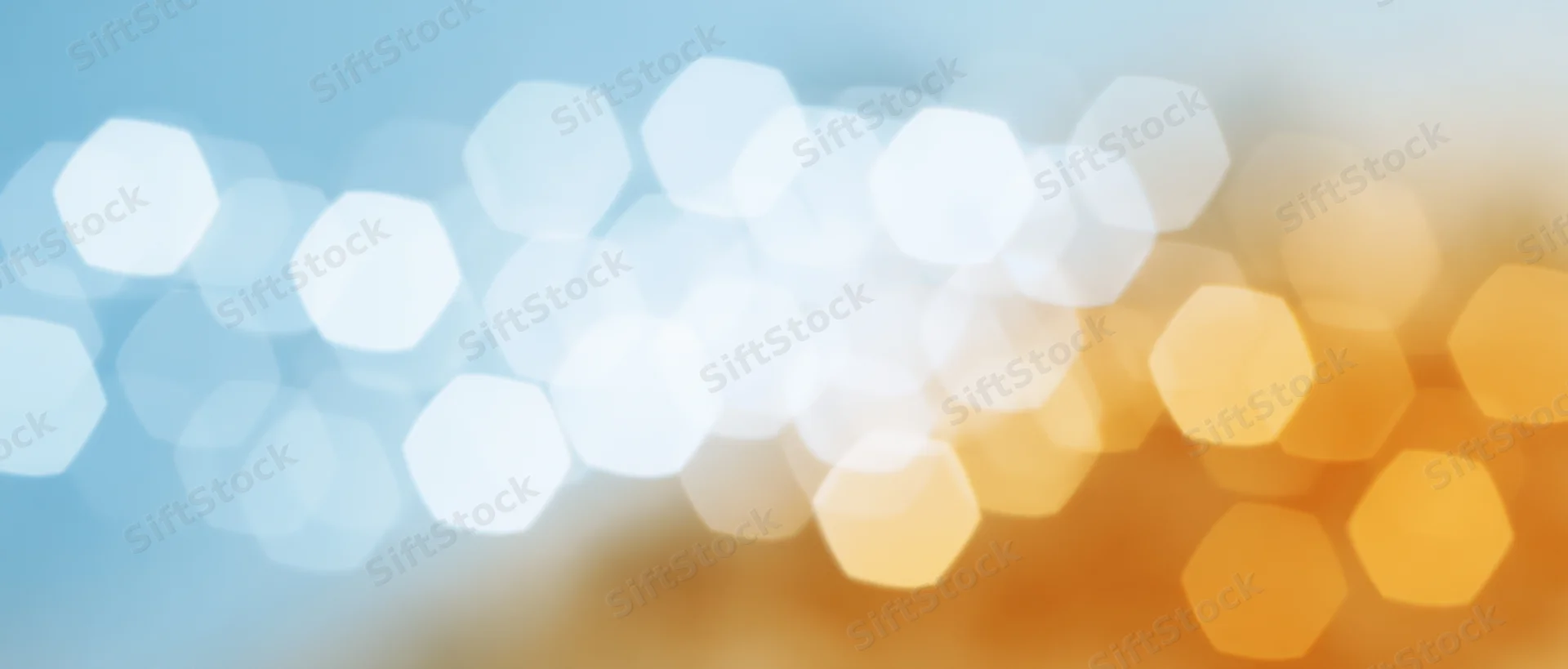 Abstract bokeh lights in soft blue and warm orange gradient with hexagonal shapes and blurred glow