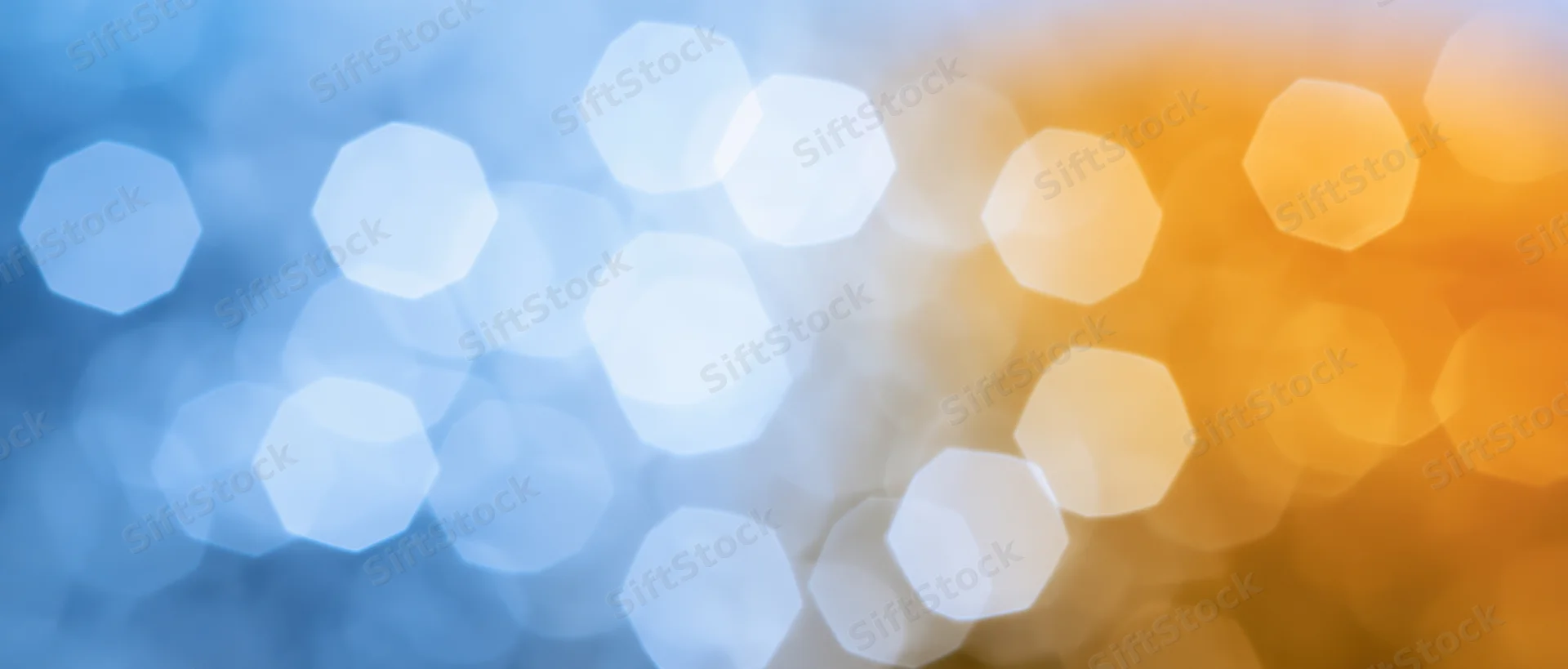 Blurred hexagonal bokeh lights transitioning from blue to orange across the frame