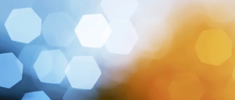 Blurred hexagonal bokeh lights transitioning from blue to orange across the frame