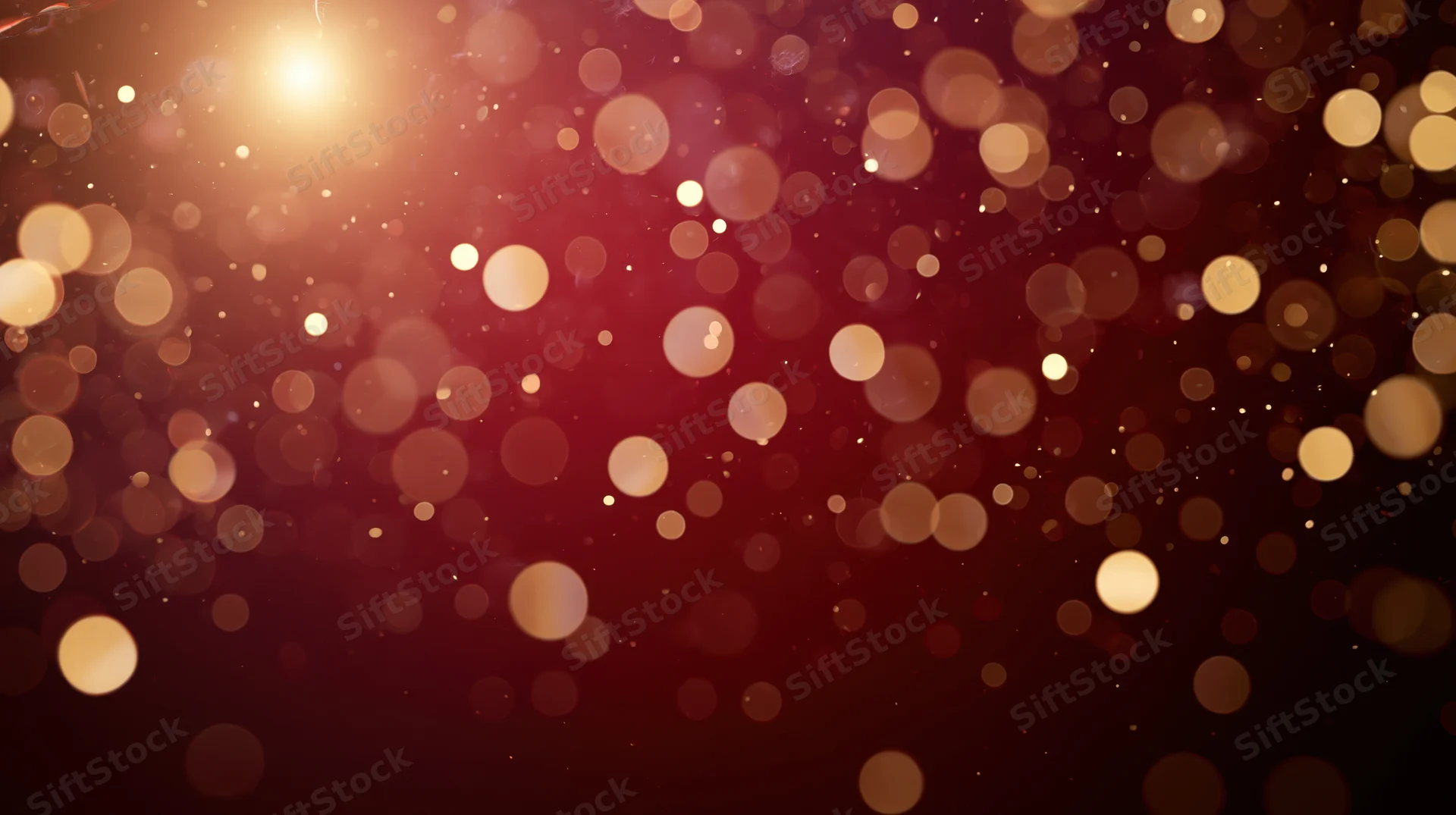 Warm glowing bokeh lights in red and gold with soft sparkle and copyspace for festive holiday background
