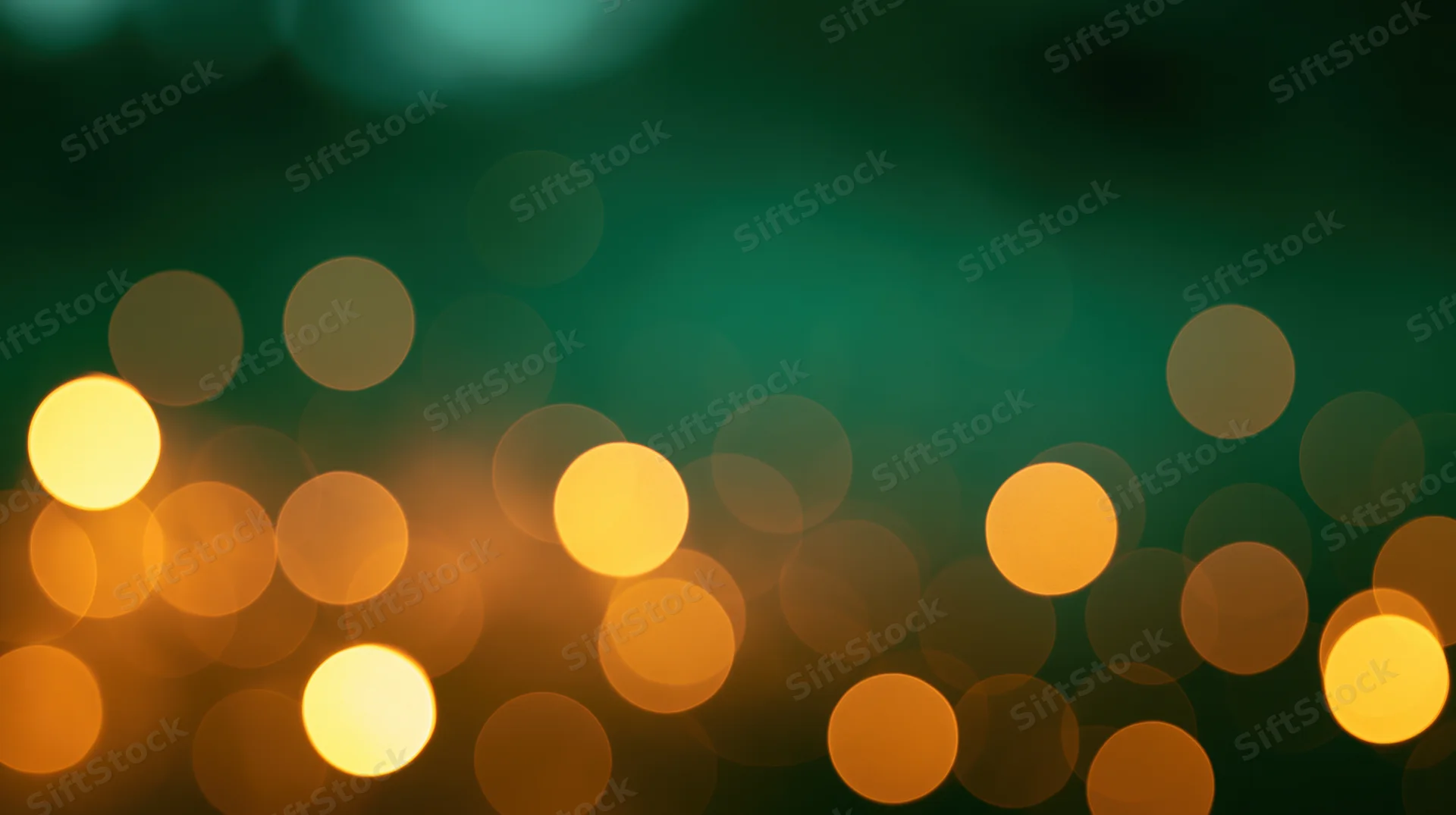 Blurred circular lights in warm orange and yellow tones against a dark green background, creating a soft glowing bokeh effect