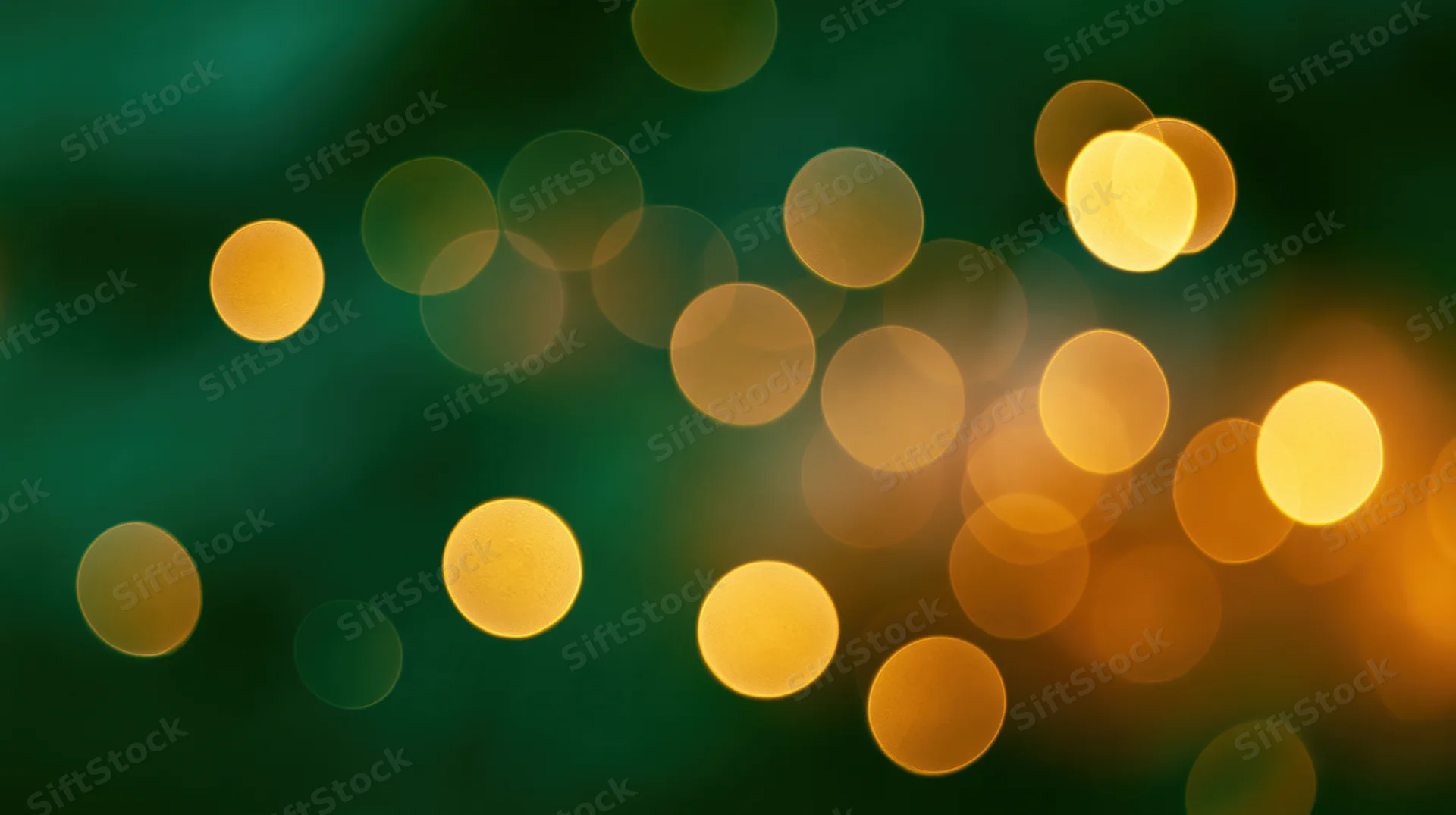 Golden bokeh lights scattered across a dark green background with soft glow and festive ambiance