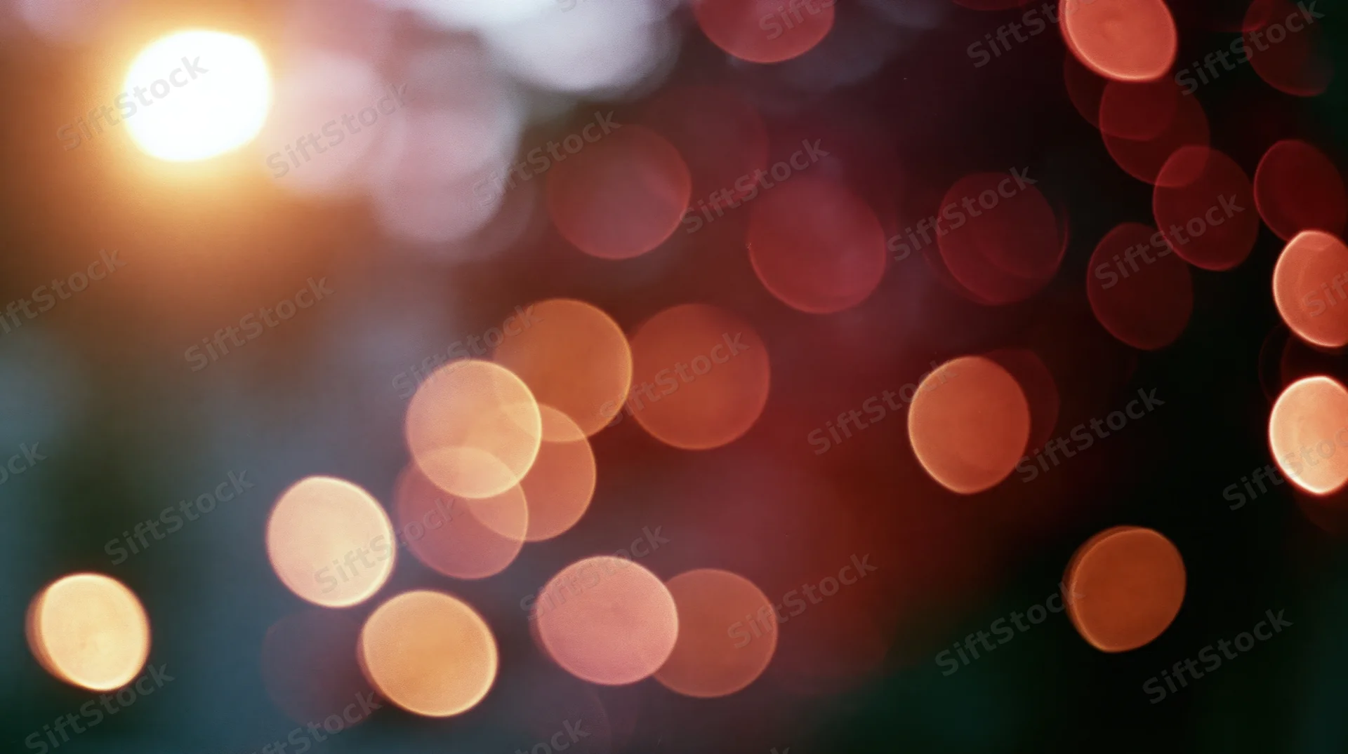 Blurred circular lights in warm tones arranged across a dark background with soft glow and bokeh effect