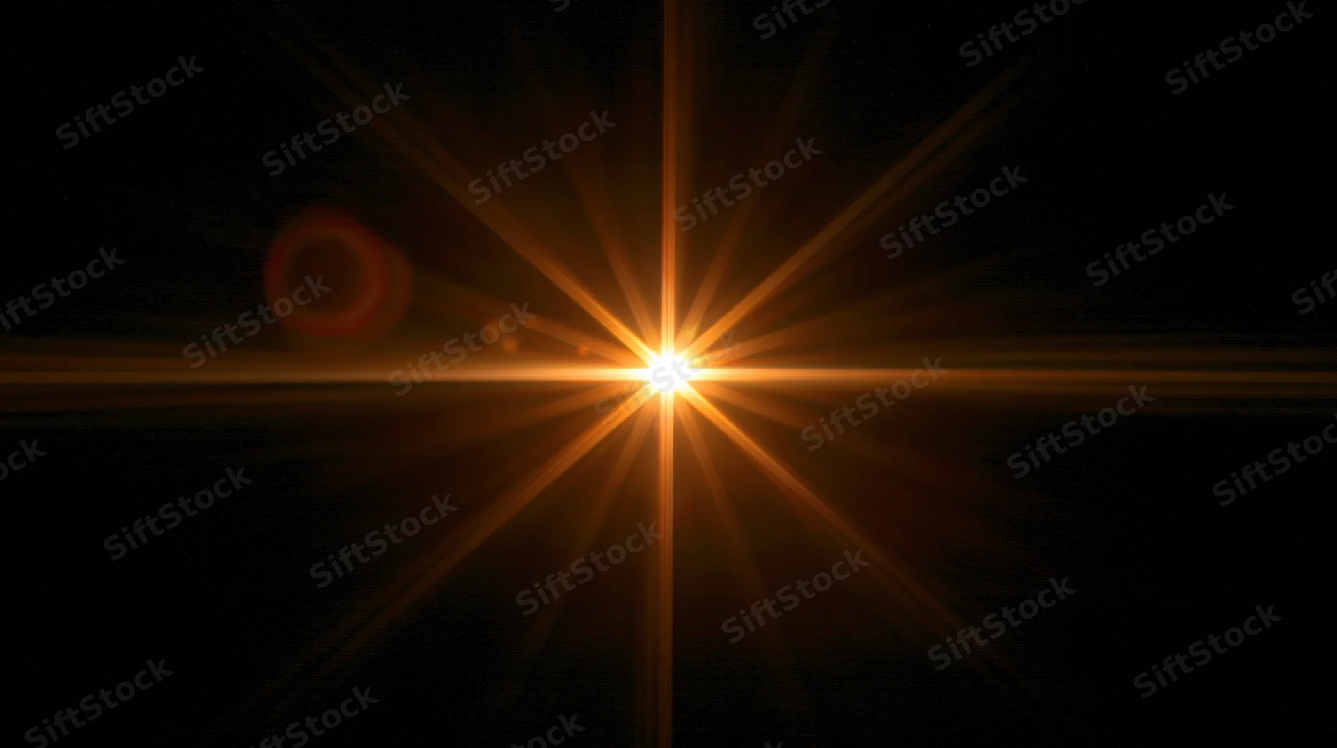 Bright golden starburst light flare centered on black background with radiating beams and lens flare effects