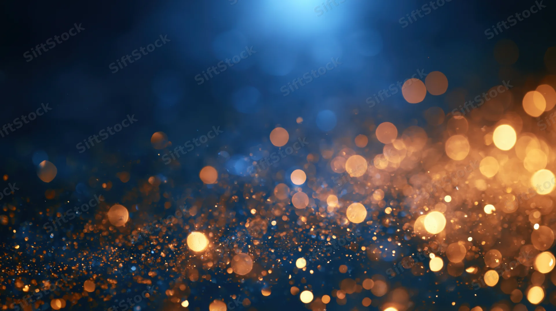 Golden bokeh lights shimmering against a deep blue background with soft glow and festive ambiance