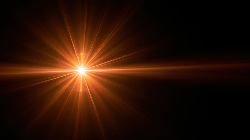 Bright orange light burst radiating from center against black background with copyspace on right