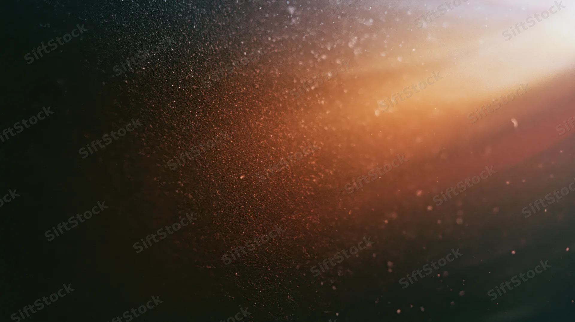 Floating dust particles illuminated by warm light against a dark gradient background