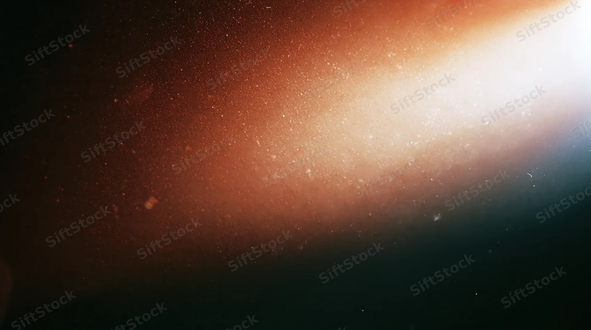 Glowing orange light with floating particles in dark space