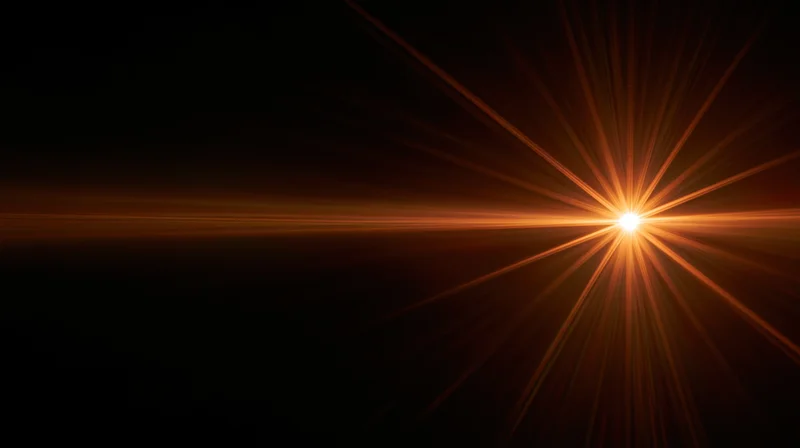 Bright golden light burst radiating from center against dark background with horizontal glow and copyspace