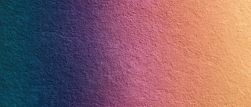 Smooth color gradient transitioning from teal to orange across a textured surface
