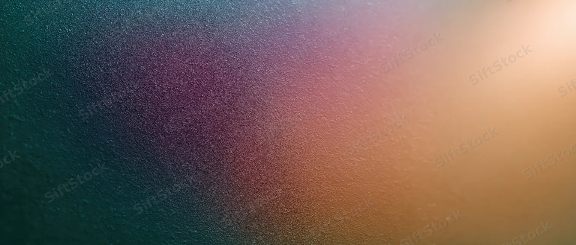 Smooth color gradient transitioning from teal to gold across a textured surface