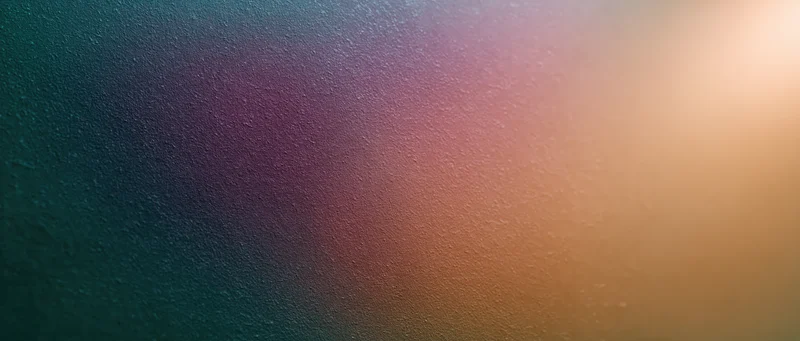 Smooth color gradient transitioning from teal to gold across a textured surface