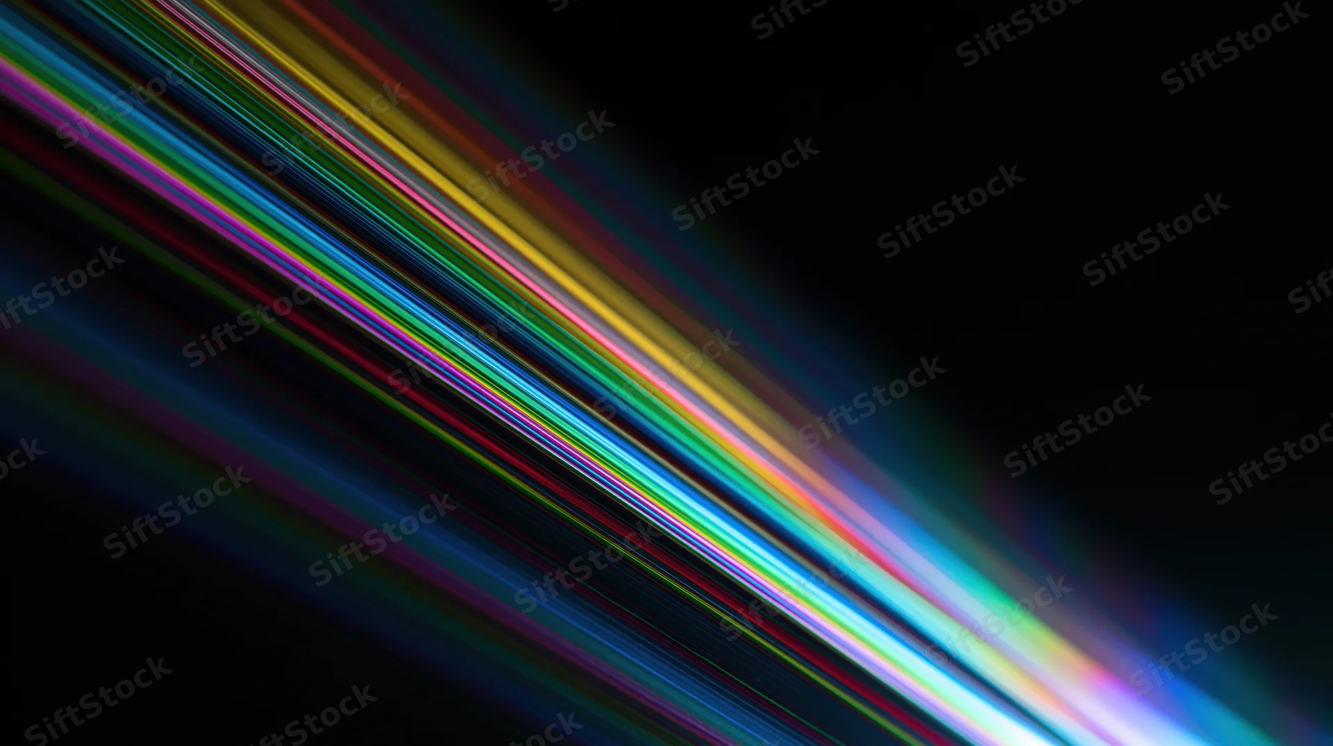 Diagonal streaks of rainbow light moving across a black background