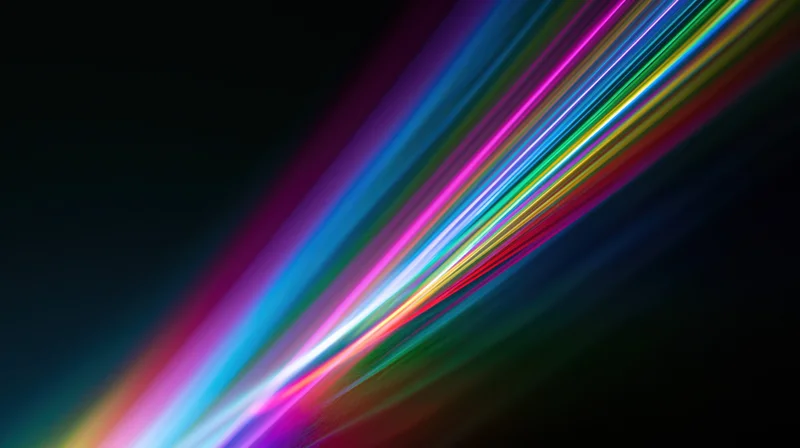 Colorful light streaks moving diagonally across a dark background