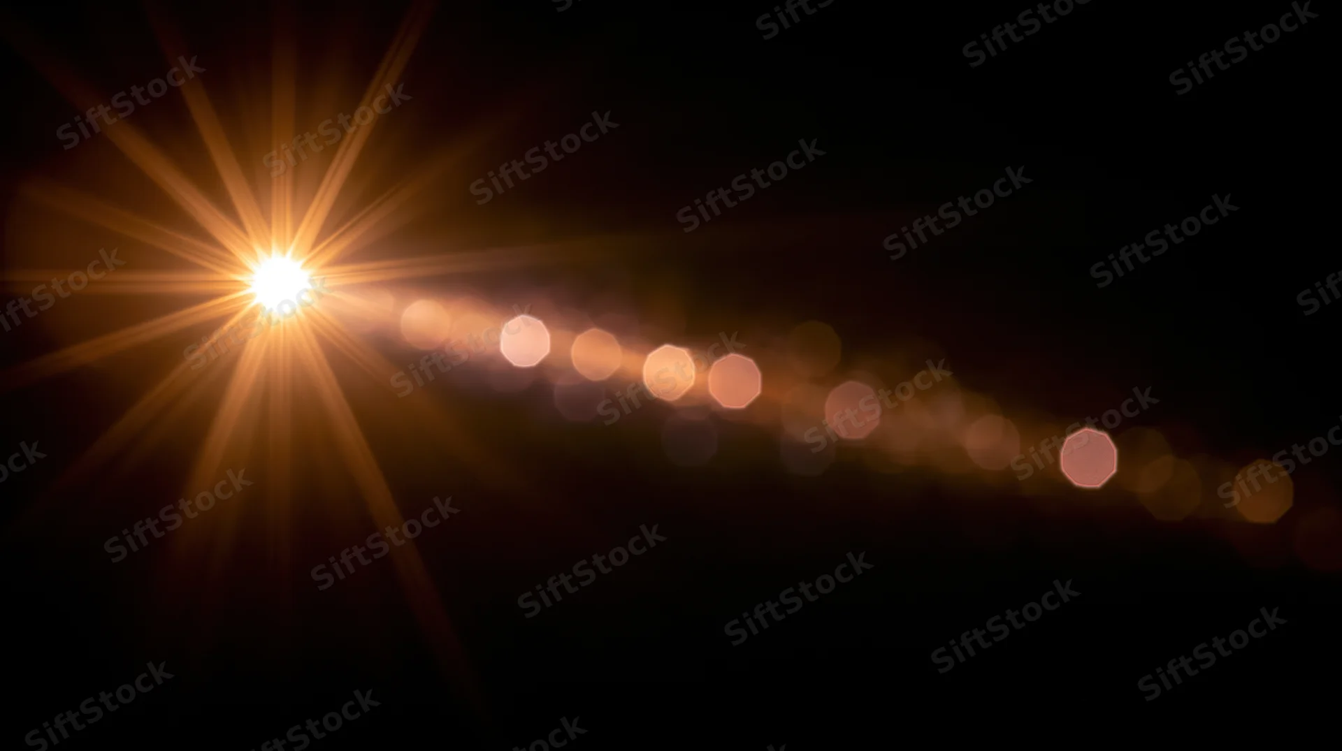 Bright starburst light with glowing bokeh trail on dark background