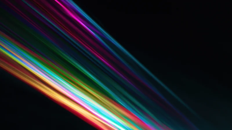 Diagonal streaks of rainbow-colored light across a black background