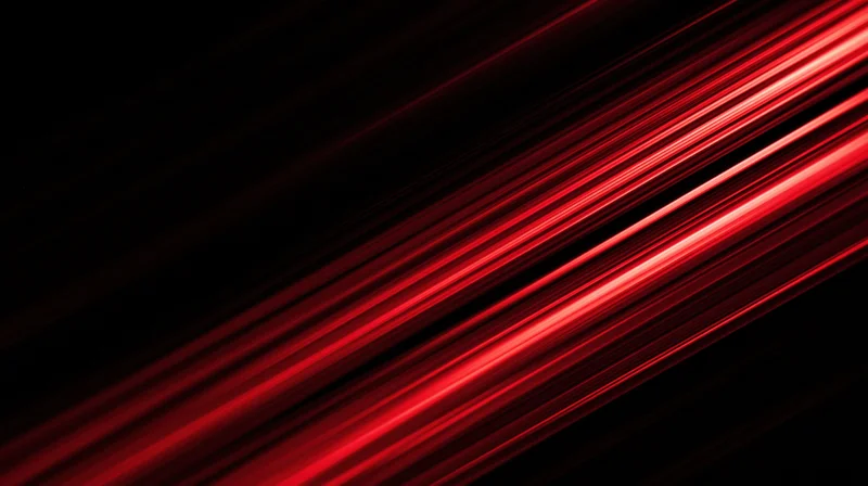 Diagonal red light streaks moving across a dark background