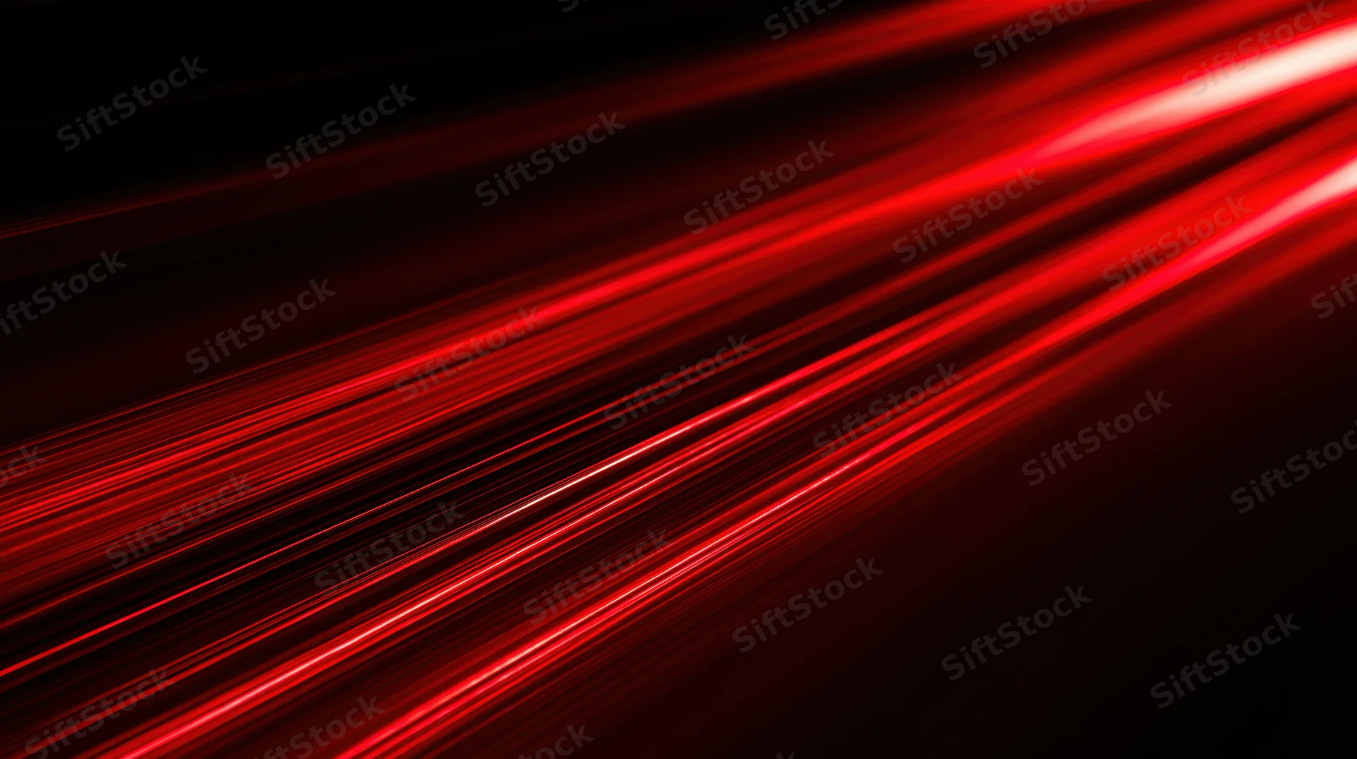 Diagonal red light streaks moving across a dark background with motion blur and glow
