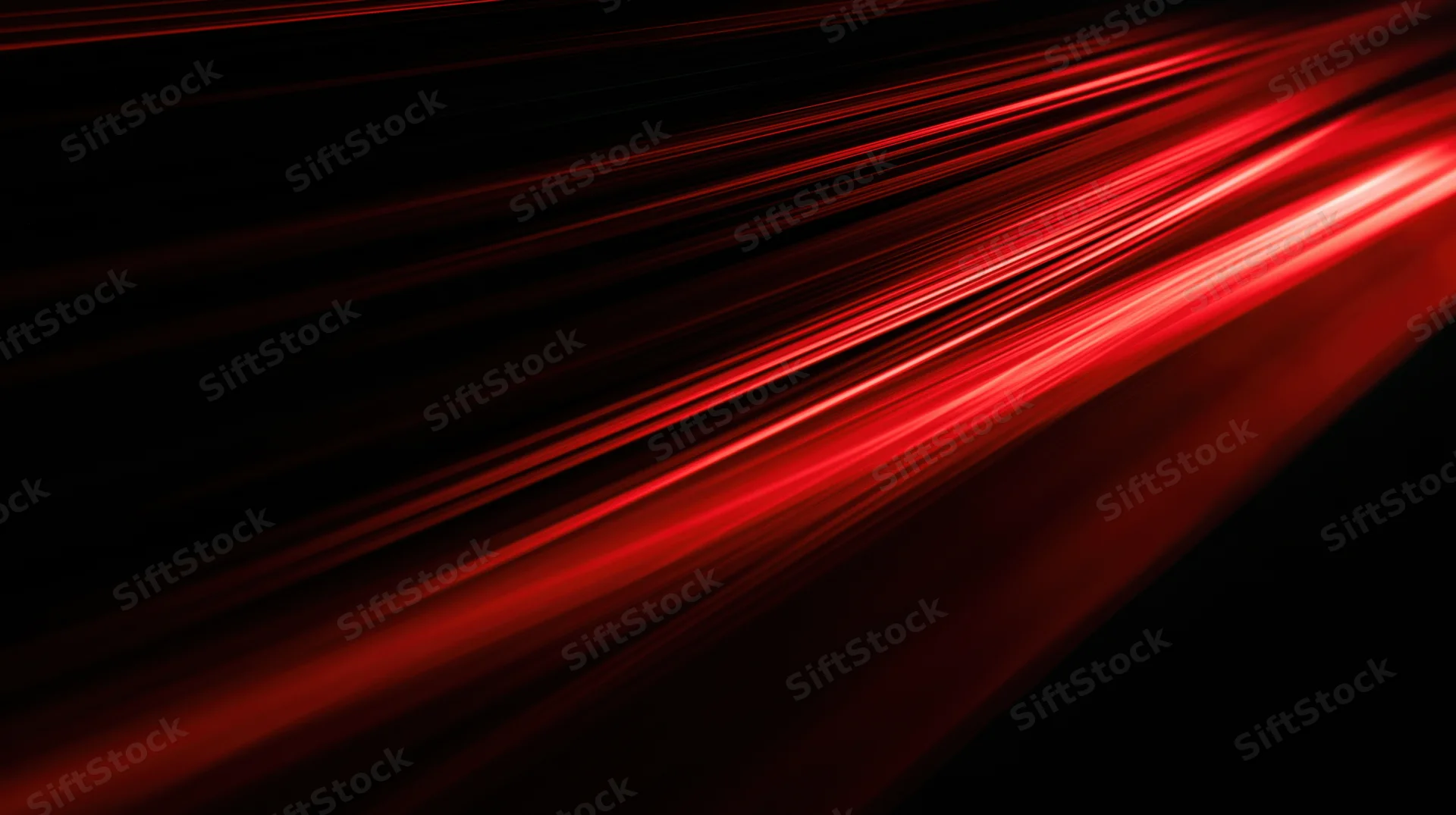 Diagonal red light streaks moving across a dark background