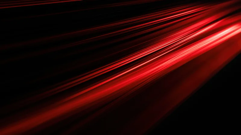 Diagonal red light streaks moving across a dark background