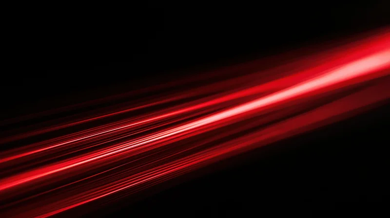 Red light streaks moving diagonally across a black background