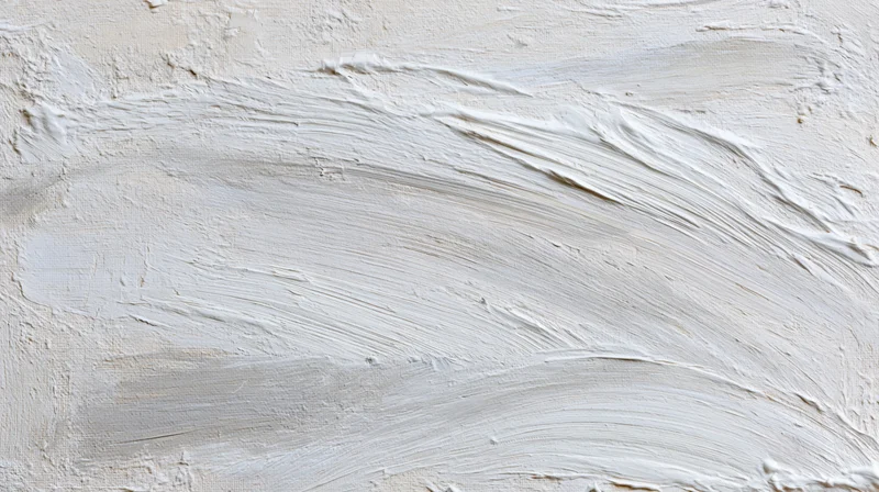 White paint applied in broad brushstrokes across canvas surface