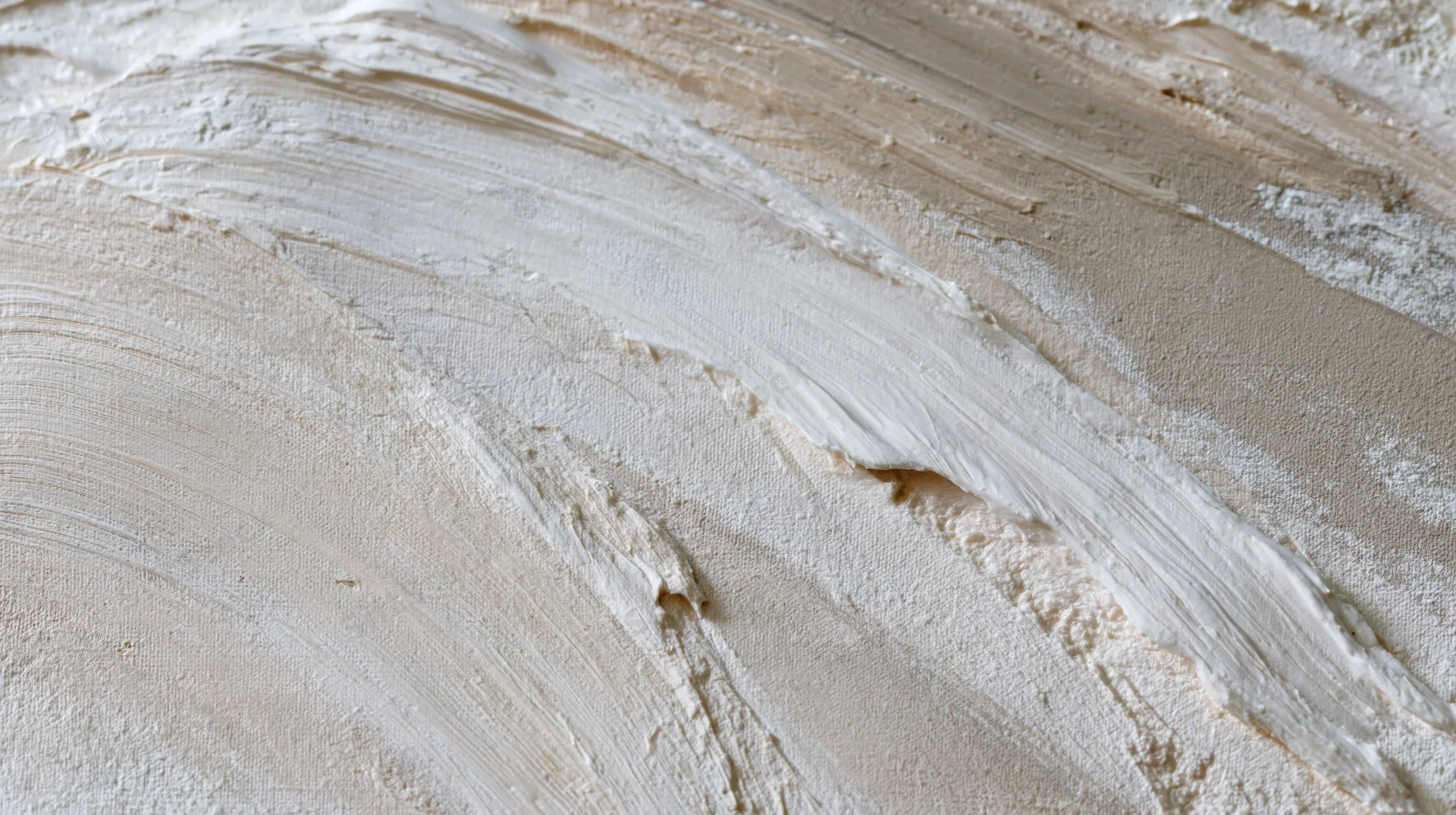 Close-up of textured plaster wall with layered brushstrokes and subtle color variations