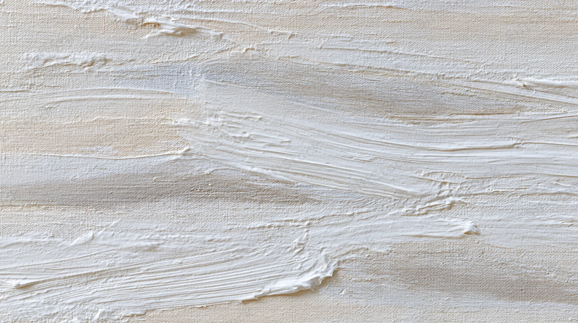 White paint applied in textured brushstrokes across canvas surface