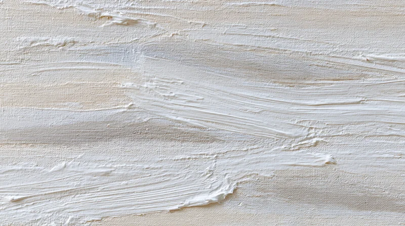 White paint applied in textured brushstrokes across canvas surface