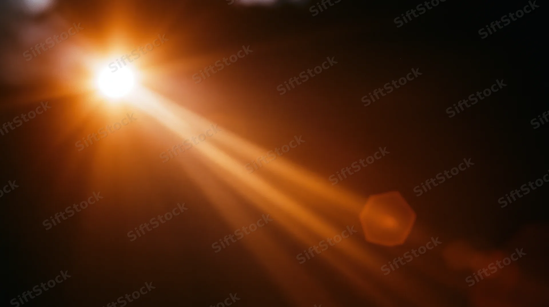 Bright sun casting warm rays and lens flare across dark sky