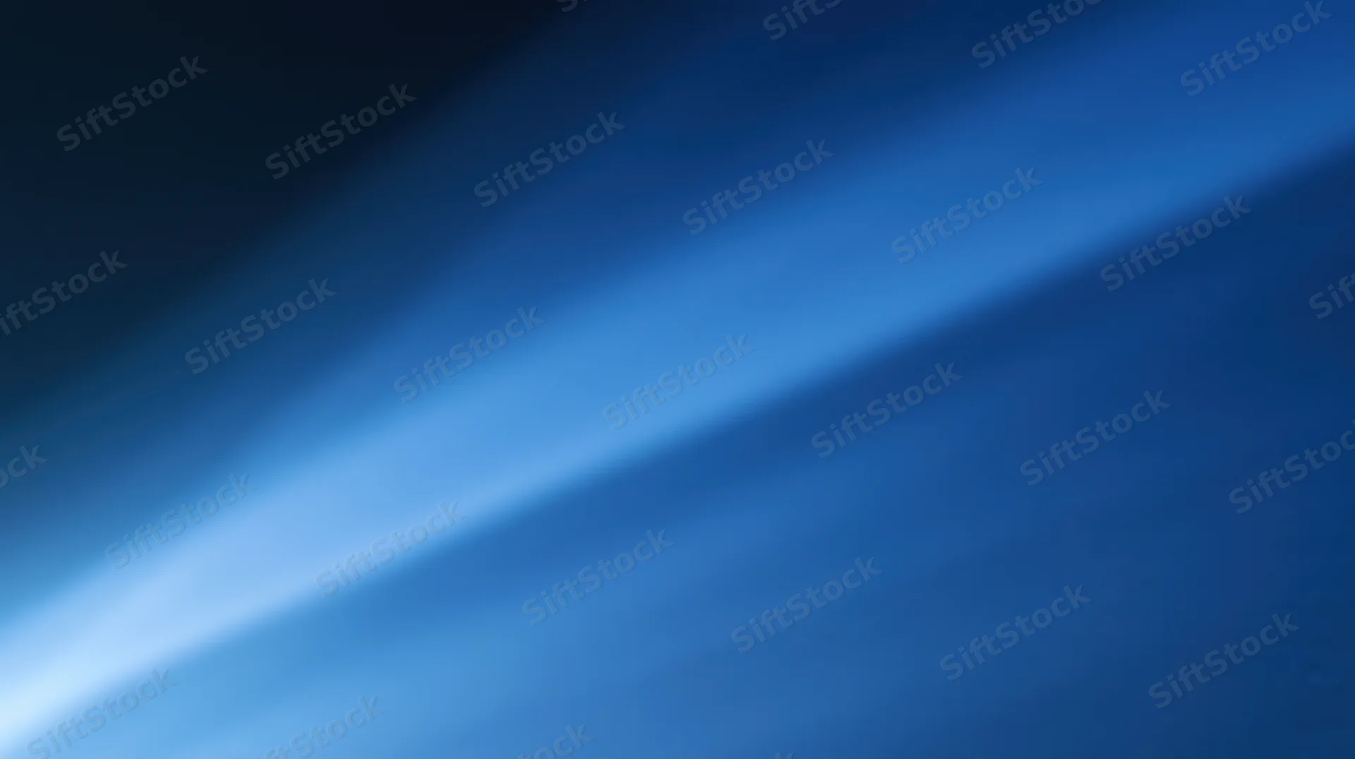 Diagonal blue light gradient across abstract background with soft glow and copyspace