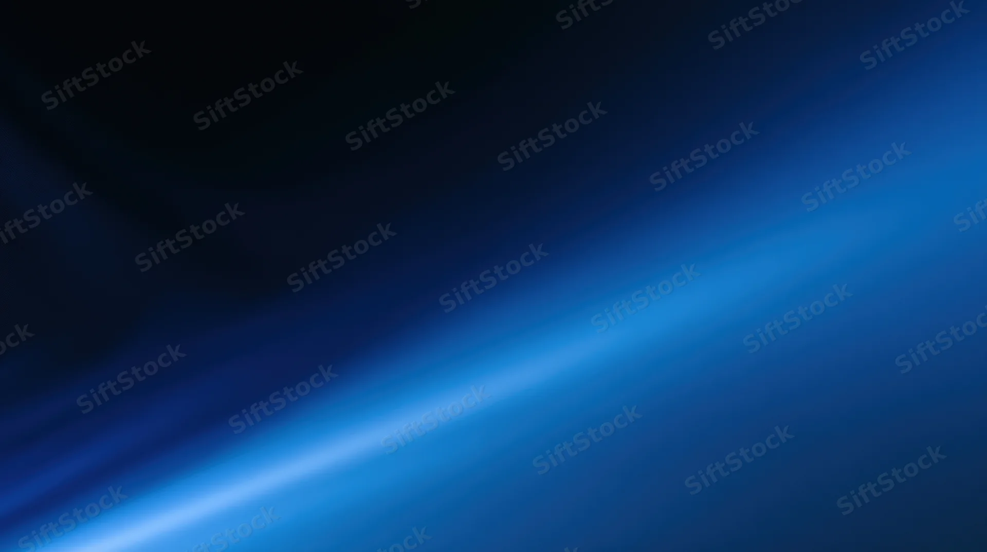 Diagonal blue light gradient across dark abstract background with soft glow and smooth texture