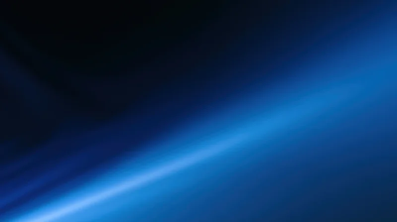 Diagonal blue light gradient across dark abstract background with soft glow and smooth texture