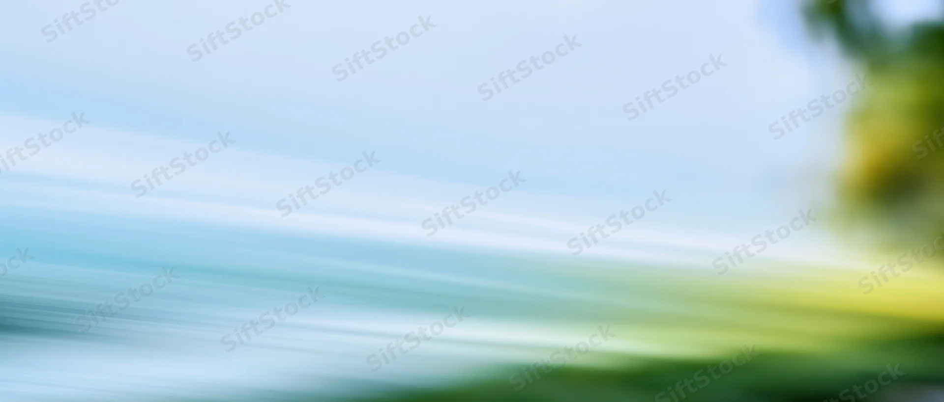 Blurred motion streaks of light and color across a natural outdoor scene