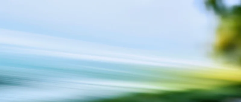 Blurred motion streaks of light and color across a natural outdoor scene