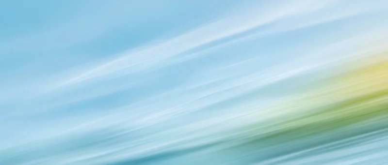 Abstract gradient background with flowing light streaks in blue and pastel hues