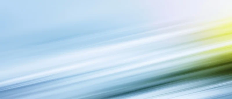 Abstract motion blur with diagonal light streaks in blue and yellow gradient