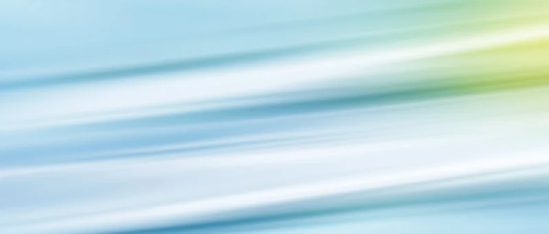 Abstract gradient background with flowing diagonal light streaks in blue green and yellow hues
