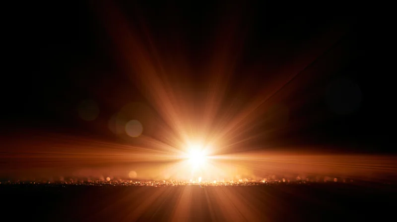 Bright sunrise with radiant beams over city skyline at dawn