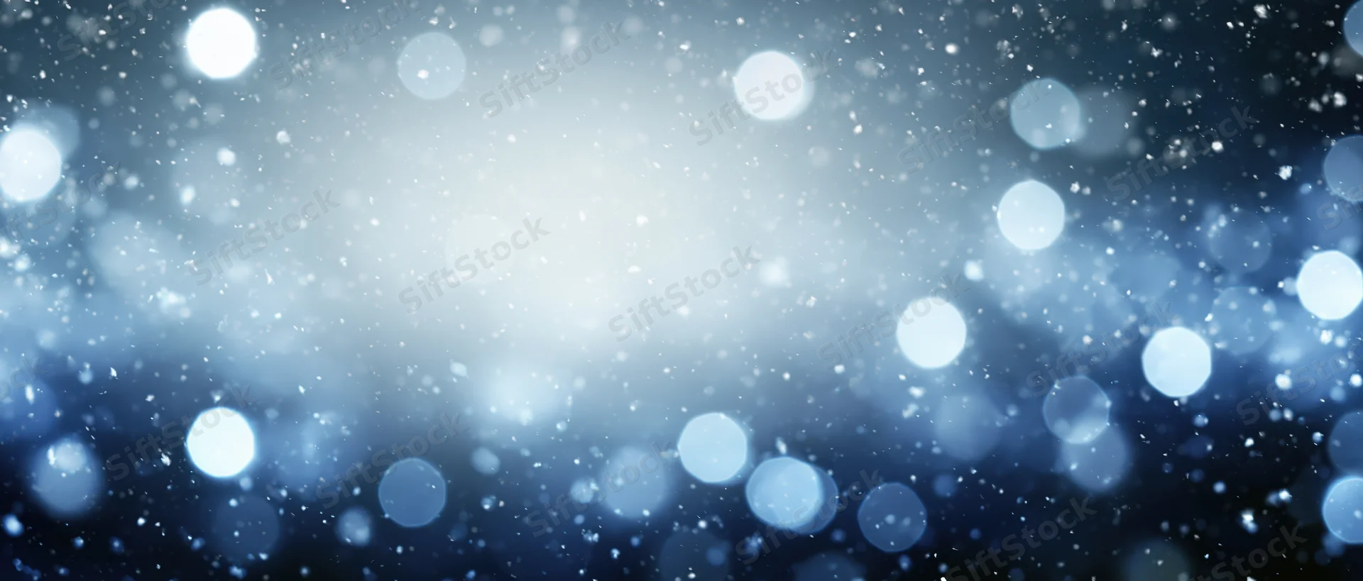 Abstract blue and white bokeh lights with soft glow and scattered particles as background