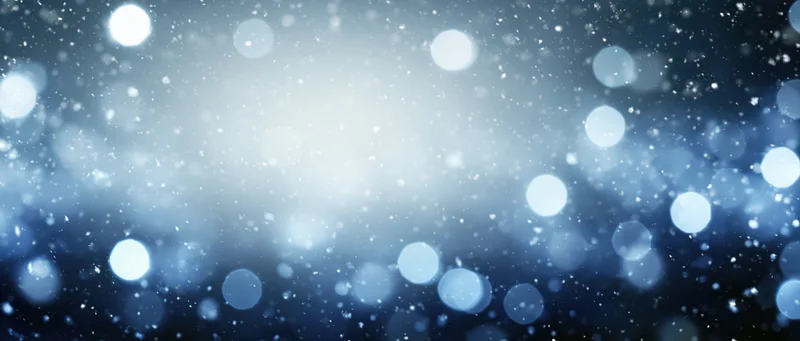 Abstract blue and white bokeh lights with soft glow and scattered particles as background
