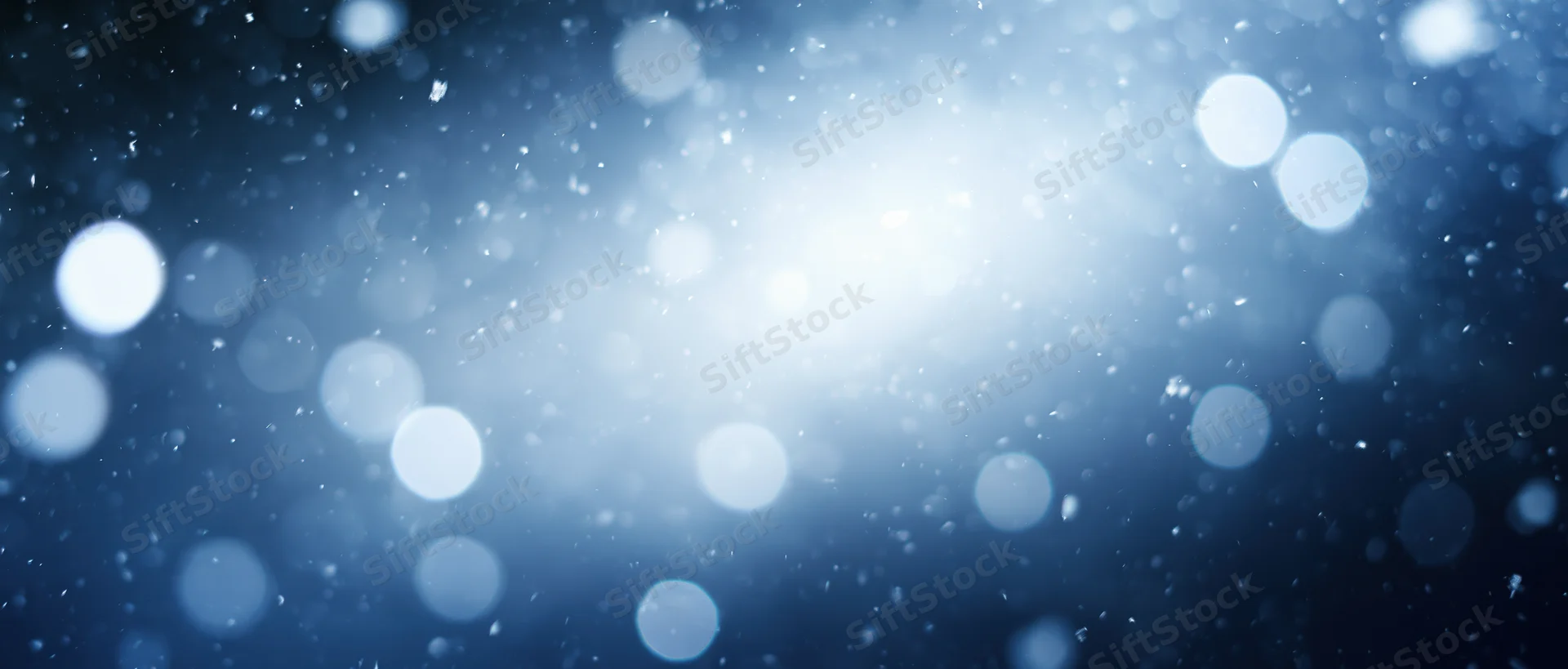 Abstract blue bokeh lights with soft glow and floating particles as background