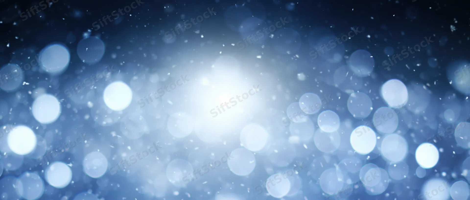 Abstract blue bokeh lights with soft glow and scattered particles as background