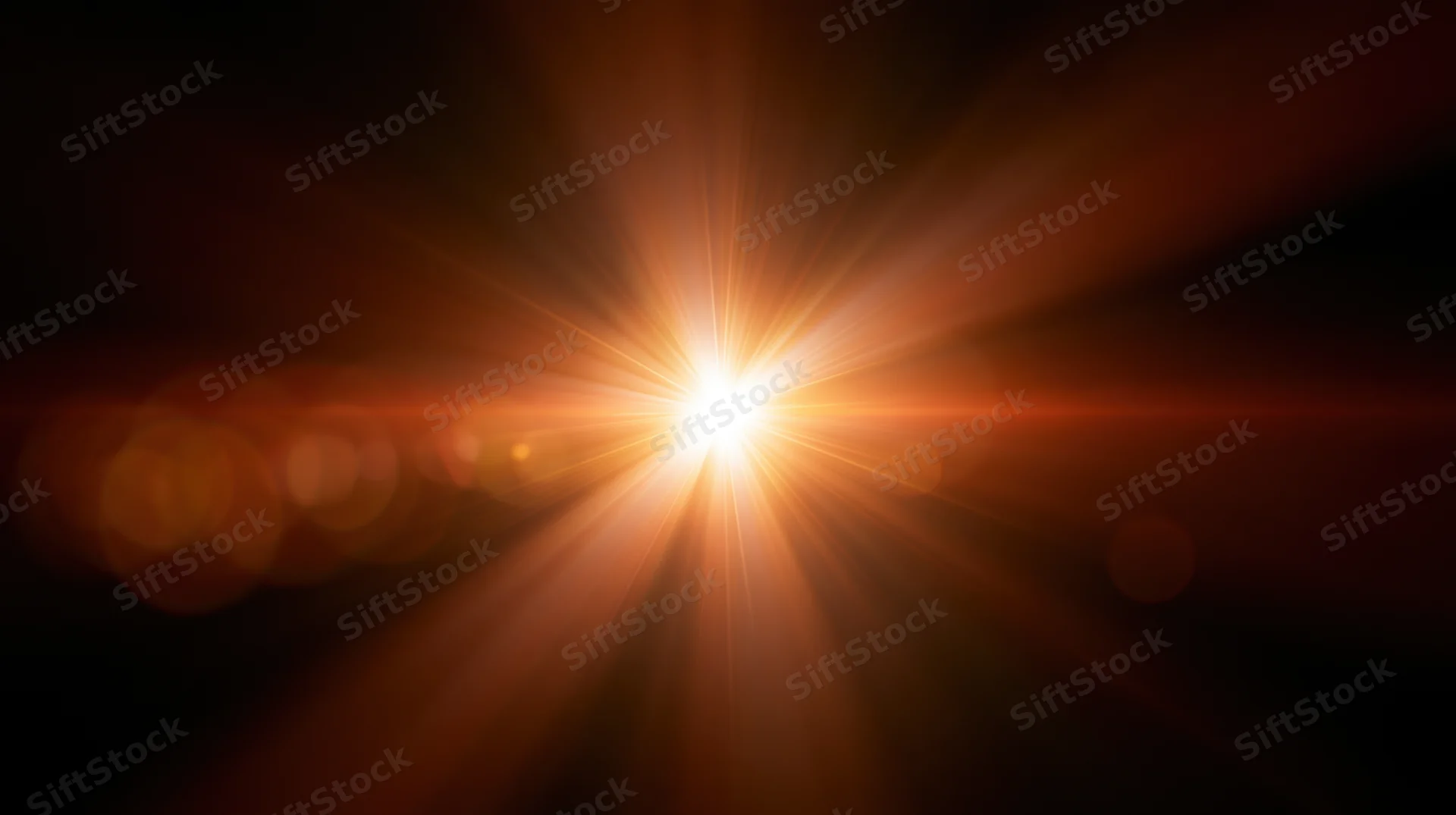 Bright orange light burst with lens flare and bokeh against dark background