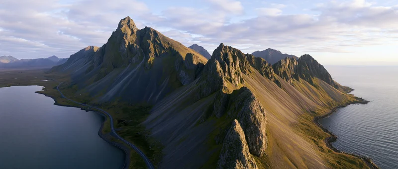 Rugged mountain peaks along a winding coastal road in Norway