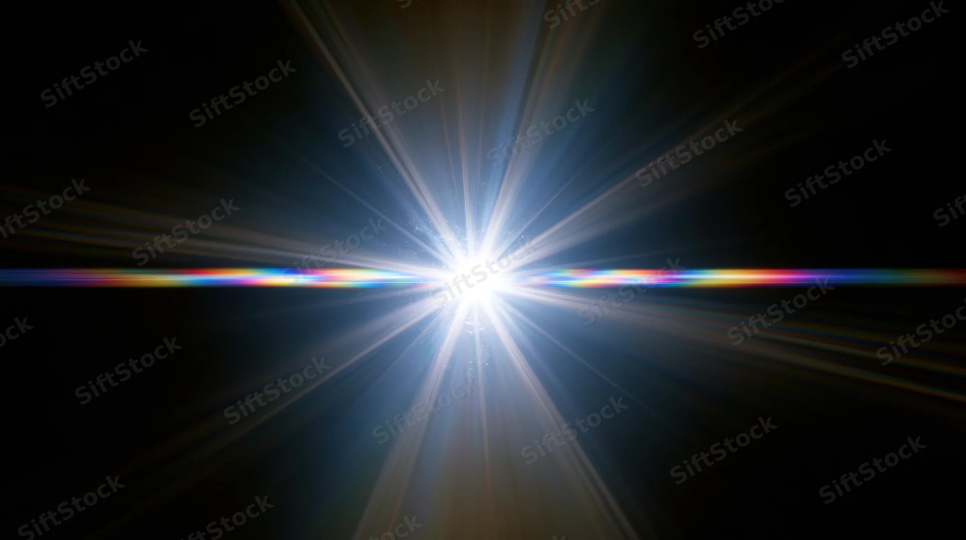 Bright starburst light flare with radial beams and horizontal rainbow spectrum against black background
