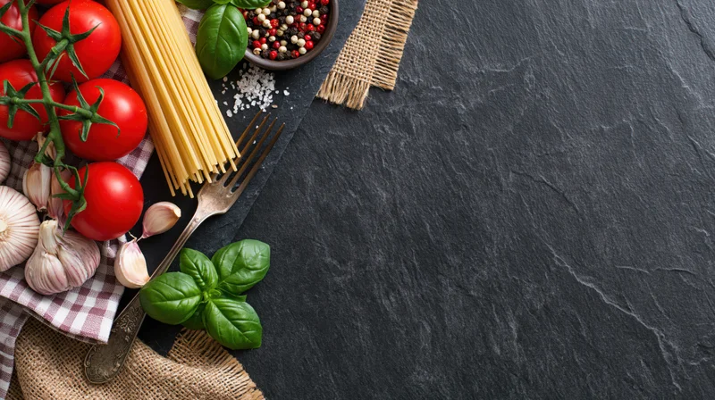 Fresh Italian pasta ingredients arranged on slate with copyspace