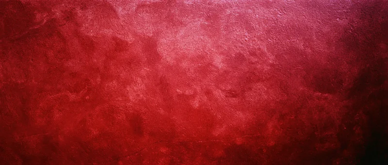 Abstract red textured surface with gradient shading and rough finish